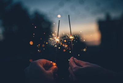 two-hand-holding-new-year-sparklers