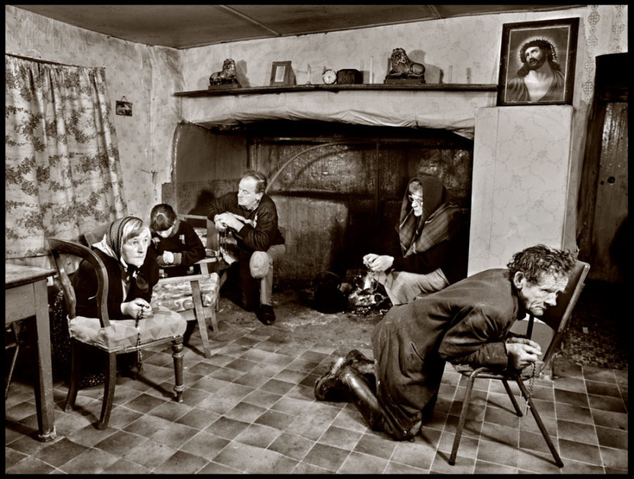 people kneeling saying the rosary at a farmhouse in Co Waterford, 1991