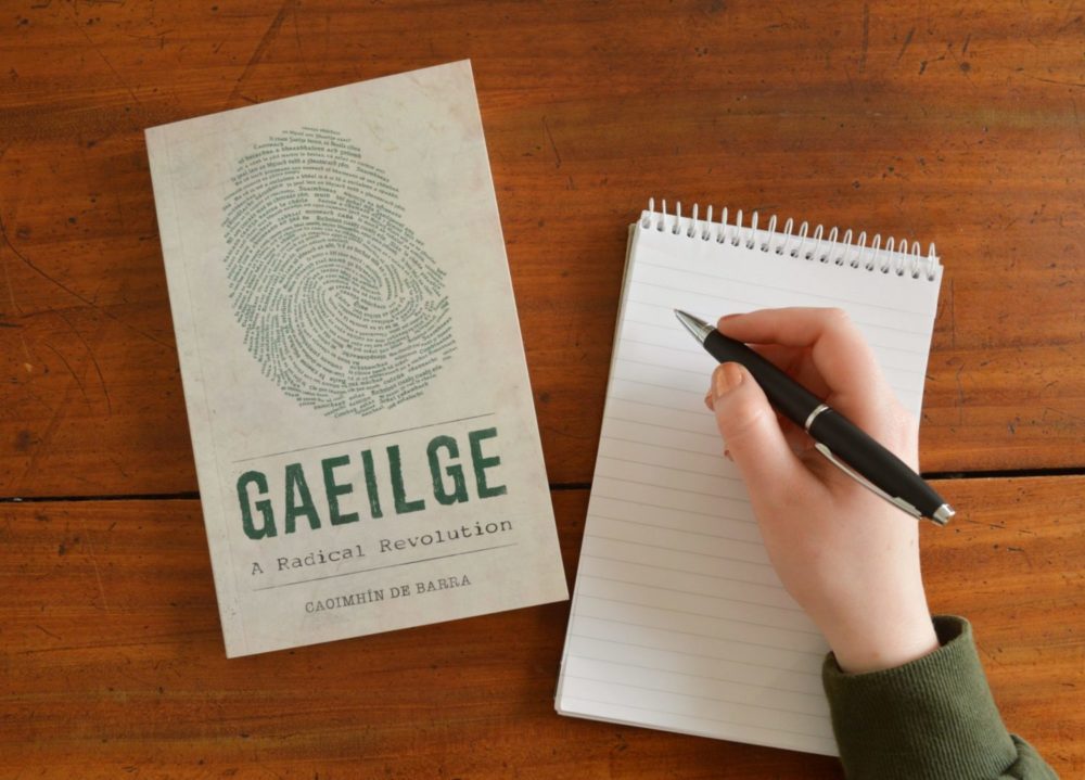 Copy of Gaeilge A Radical Revolution with a pen and notepad